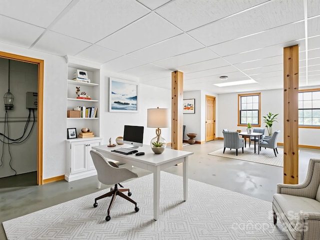 416 Hunters Glen Ln, Hendersonville, NC 28739 - office area featuring built in shelves, baseboards, finished concrete floors, and a paneled ceiling