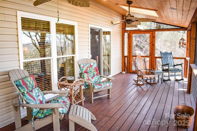 sunroom / solarium featuring lofted ceiling, wood ceiling, and ceiling fan