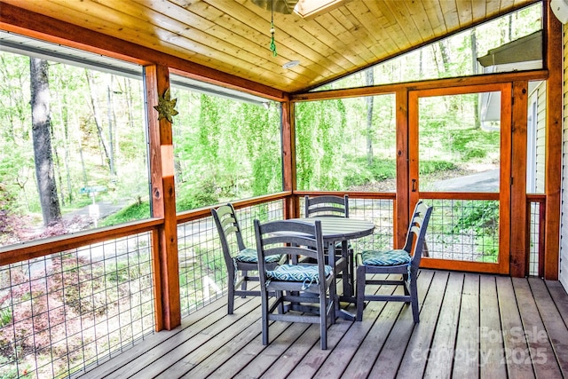 sunroom / solarium featuring lofted ceiling with skylight and wooden ceiling