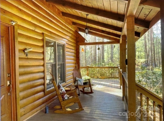 sunroom with wood ceiling, a healthy amount of sunlight, and lofted ceiling with beams