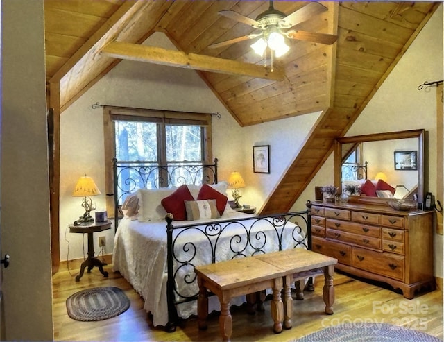 bedroom featuring vaulted ceiling with beams, wood finished floors, and wood ceiling