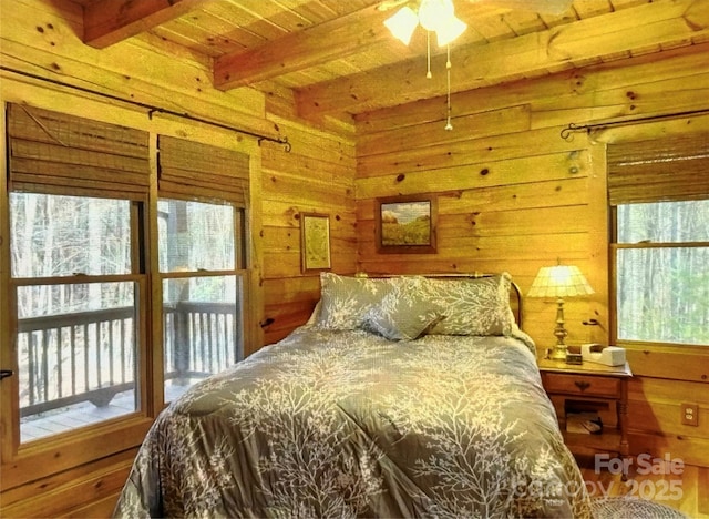 bedroom with wooden ceiling, wooden walls, and beamed ceiling