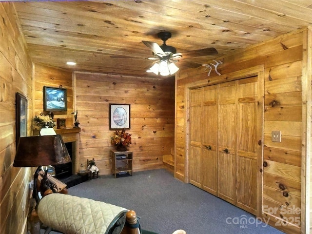 living area with wooden ceiling and wooden walls