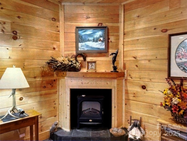 interior space featuring a wood stove and wood walls