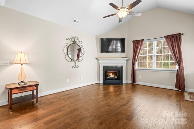 unfurnished living room with ceiling fan, wood-type flooring, and vaulted ceiling