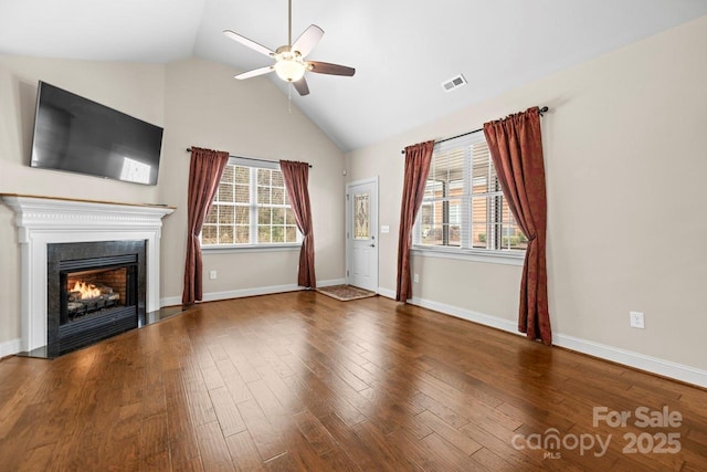 unfurnished living room with lofted ceiling, dark wood-type flooring, and ceiling fan