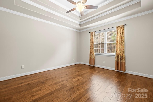 unfurnished room with crown molding, a tray ceiling, wood-type flooring, and ceiling fan