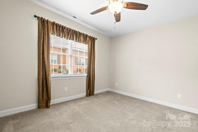 carpeted spare room with ceiling fan