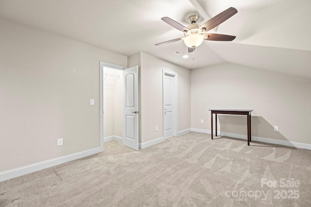 unfurnished bedroom with ceiling fan, lofted ceiling, and light carpet