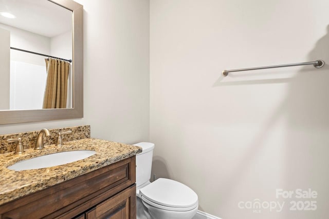 bathroom featuring vanity, toilet, and a shower with shower curtain