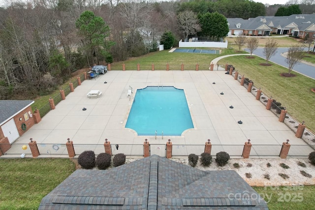 view of swimming pool with a patio area and a lawn