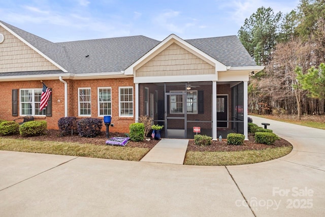 view of front of home with a sunroom and ceiling fan