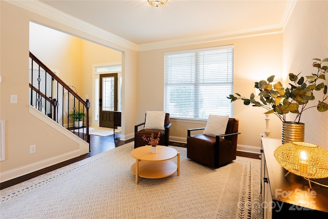 sitting room featuring hardwood / wood-style flooring and ornamental molding