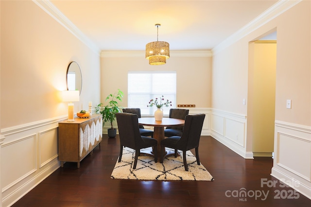 dining area with crown molding and dark hardwood / wood-style flooring