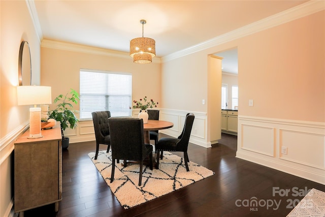 dining space featuring ornamental molding and dark hardwood / wood-style flooring