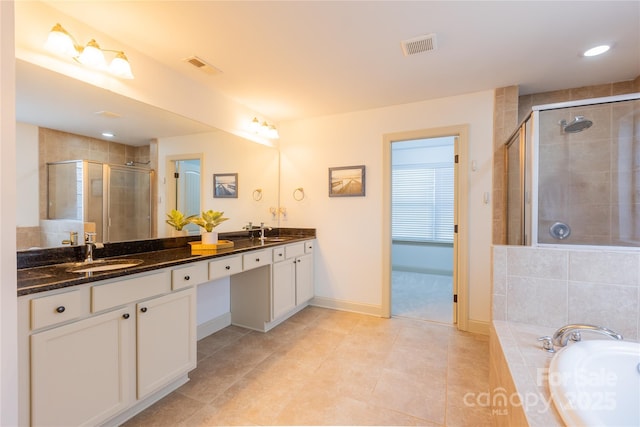 bathroom featuring vanity, tile patterned floors, and shower with separate bathtub