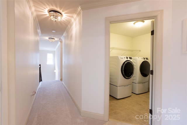 laundry room featuring crown molding, independent washer and dryer, and light colored carpet