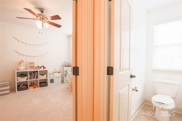 recreation room featuring carpet floors, sink, and ceiling fan