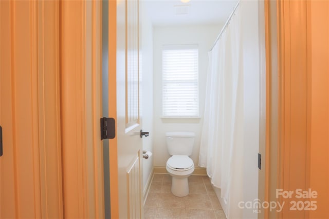 bathroom featuring tile patterned flooring and toilet