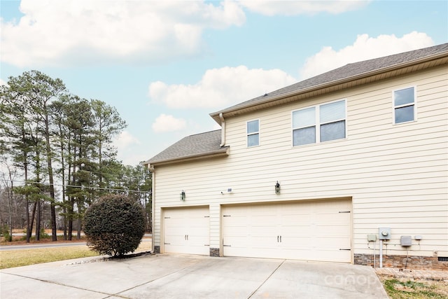 view of side of property with a garage