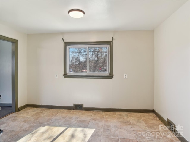 empty room with visible vents and baseboards