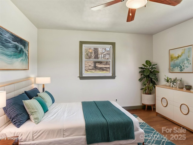 bedroom with a ceiling fan and wood finished floors