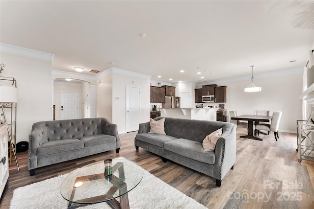 living room featuring crown molding and hardwood / wood-style floors