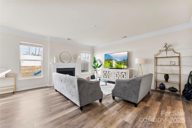 living room with crown molding and hardwood / wood-style floors