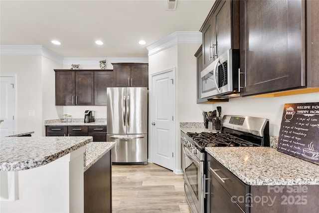 kitchen featuring dark brown cabinetry, crown molding, light hardwood / wood-style flooring, appliances with stainless steel finishes, and light stone countertops