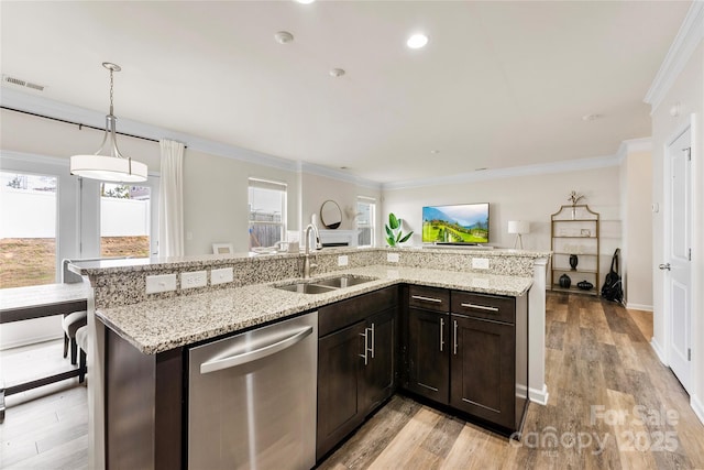 kitchen featuring sink, hanging light fixtures, dark brown cabinets, light stone counters, and stainless steel dishwasher