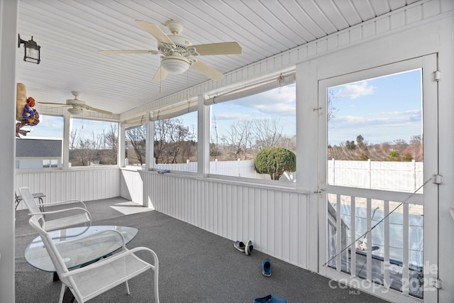 sunroom / solarium featuring ceiling fan and a wealth of natural light