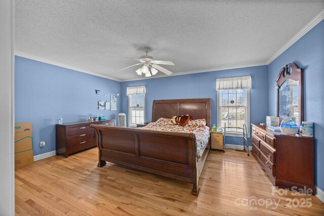 bedroom featuring crown molding, a textured ceiling, ceiling fan, and light wood-type flooring