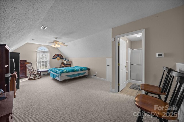 carpeted bedroom featuring ceiling fan, lofted ceiling, and a textured ceiling