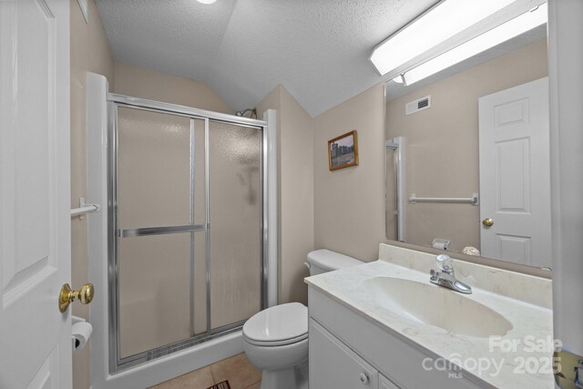 bathroom with vaulted ceiling, a shower with shower door, vanity, toilet, and a textured ceiling