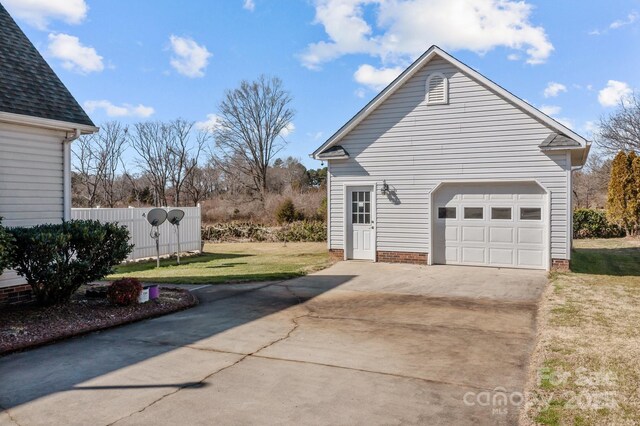 view of side of property with a garage and a yard