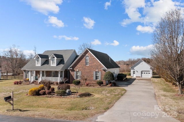 new england style home featuring an outbuilding, a garage, a front yard, and covered porch