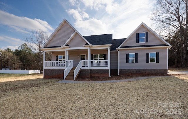 view of front of home with covered porch and a front yard