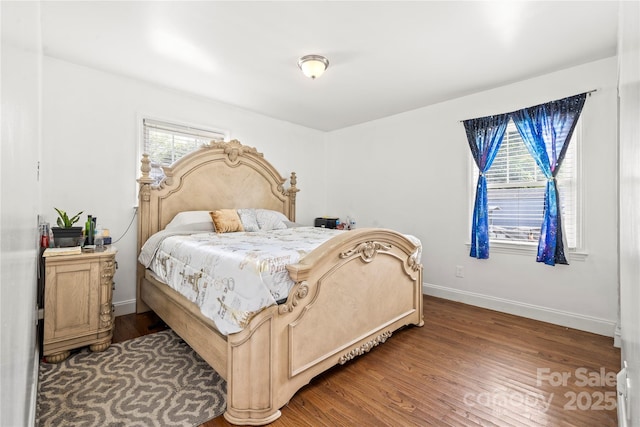 bedroom with dark wood-type flooring