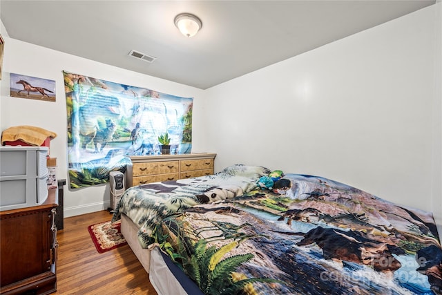 bedroom with dark hardwood / wood-style flooring