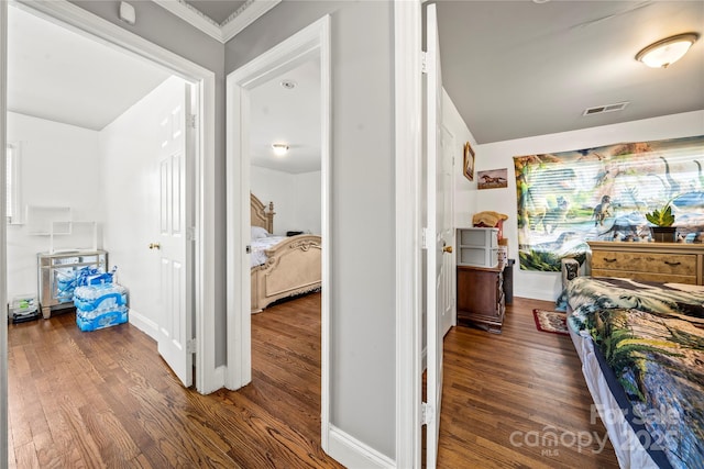 interior space with dark wood-type flooring and ornamental molding