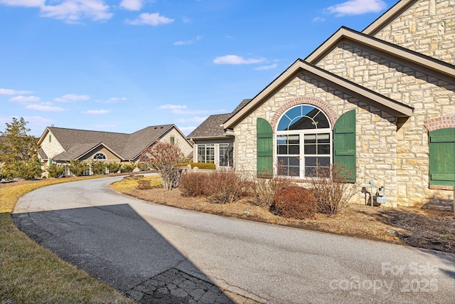 exterior space with stone siding