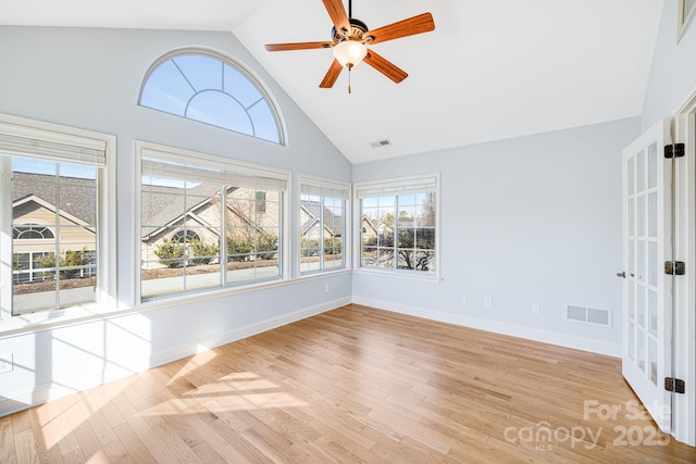 unfurnished sunroom featuring lofted ceiling, visible vents, and a healthy amount of sunlight