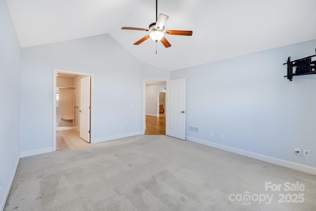 unfurnished bedroom with high vaulted ceiling, baseboards, visible vents, and carpet flooring