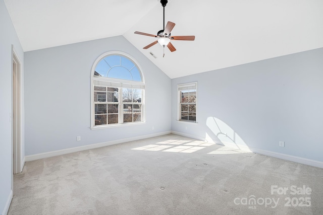 carpeted empty room featuring baseboards, high vaulted ceiling, and a ceiling fan