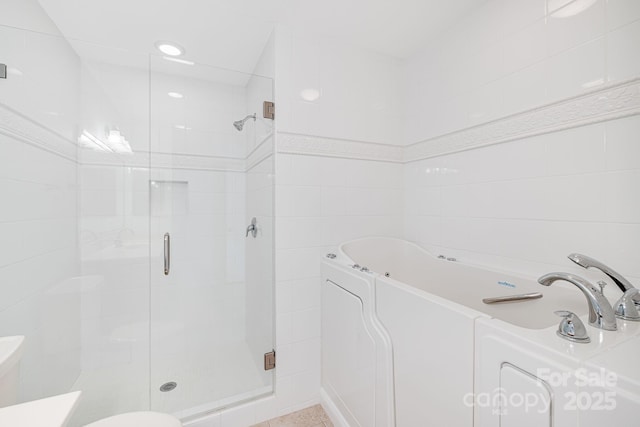 full bath featuring a garden tub, a shower stall, and toilet