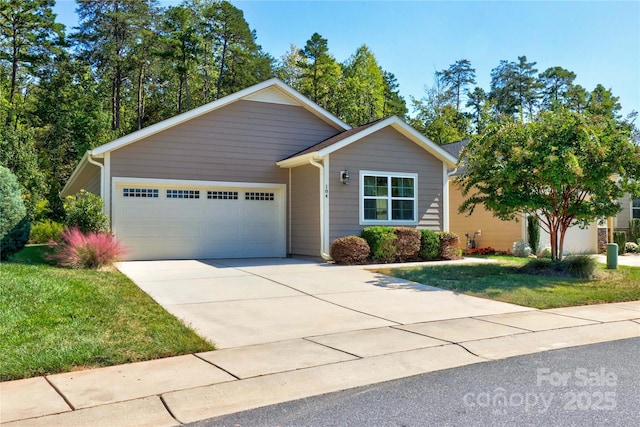 ranch-style home featuring a garage and a front lawn