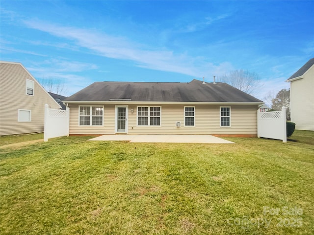 rear view of property featuring a patio and a lawn