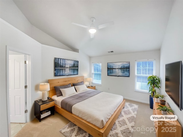 bedroom featuring ceiling fan, lofted ceiling, and light carpet