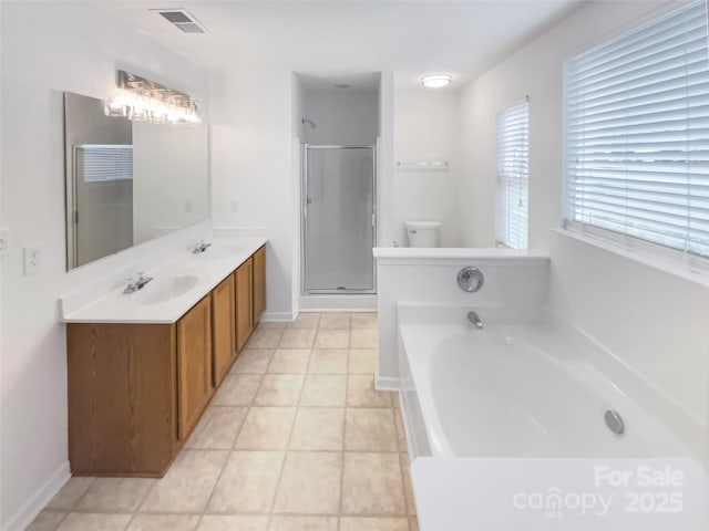 full bathroom featuring tile patterned flooring, vanity, separate shower and tub, and toilet