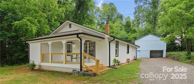 bungalow with a garage, a front yard, and covered porch